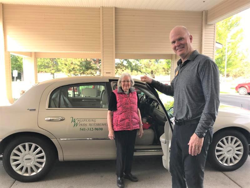 Driver Opening Car Door for Lady | Whispering Winds Retirement Transportation Service | Independent Senior Living